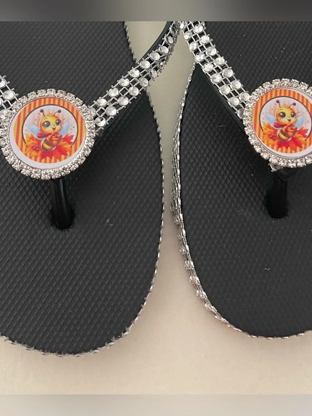 Black Bejeweled Flip Flop Sandals with Bee Medallion